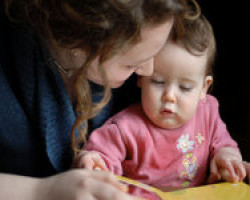 Mum Reading To Baby